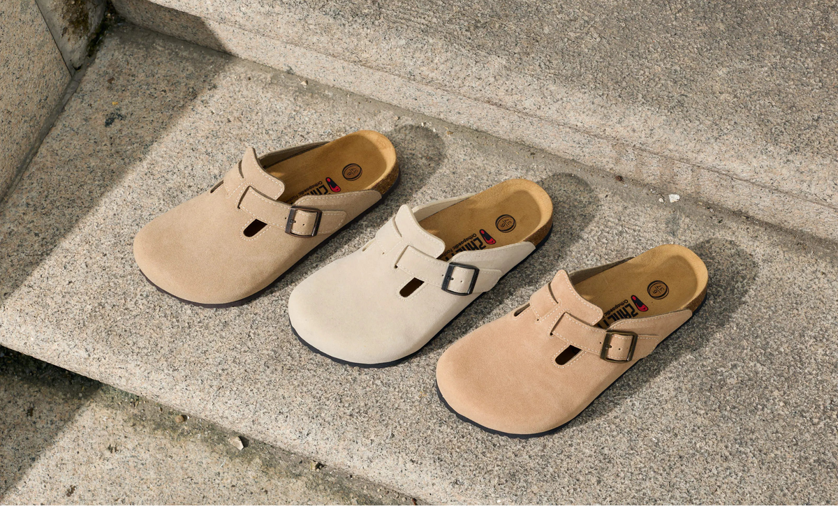 Three pairs of Soria clog sandals on stone steps